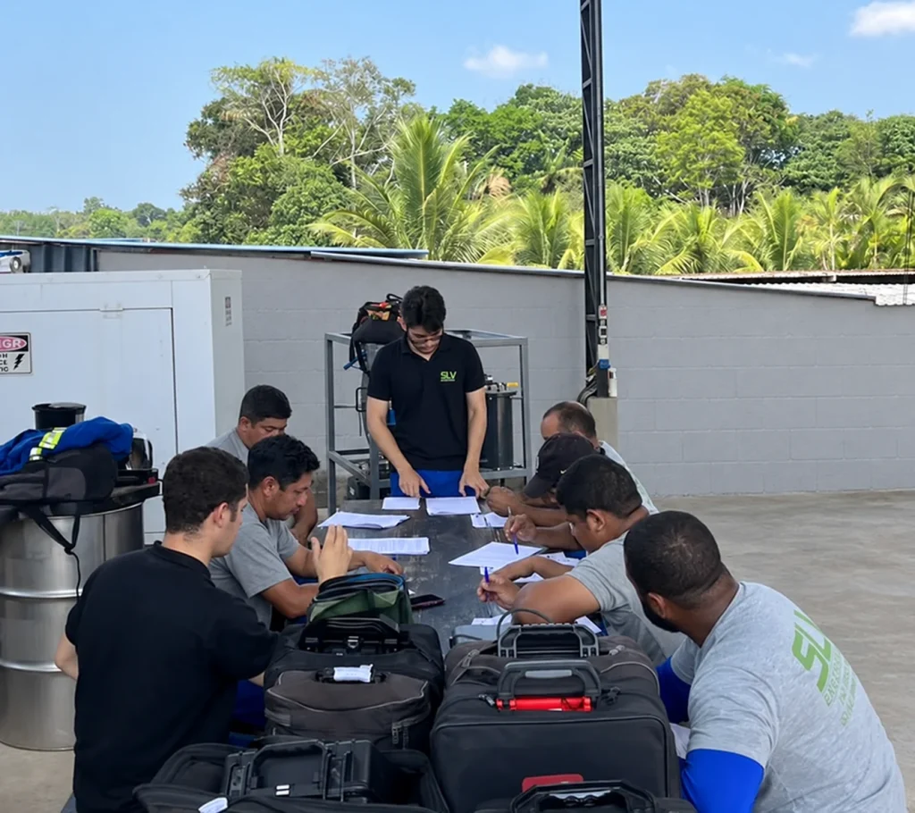 Equipe da SLV reunida em torno de documentos técnicos.